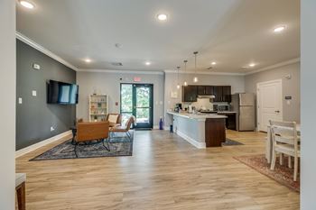 a living room with a kitchen and an open floor plan